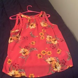 A pink top with flowers on it